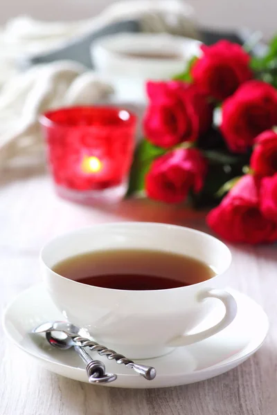 Valentine\'s Day: Romantic Tea Party with candle and bouquet of