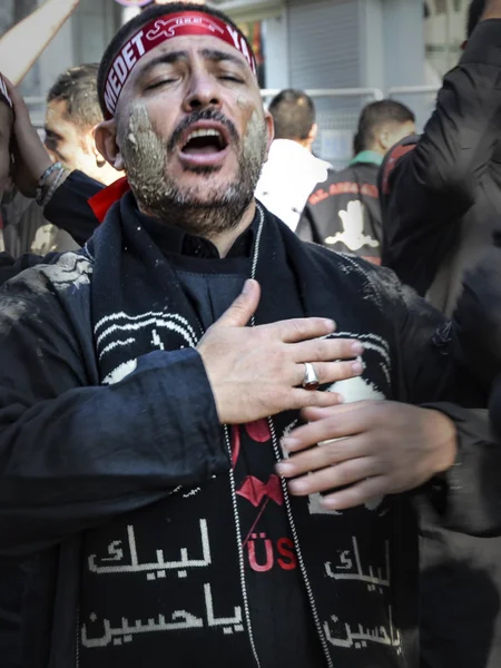 Shia Muslim men shout Islamic slogans Ashura procession