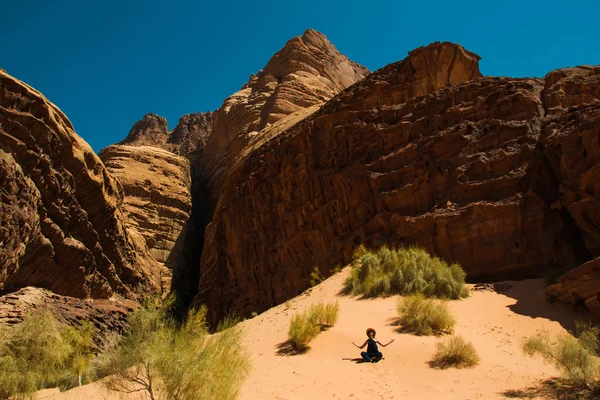 Inspiration retreat concept. Girl relaxing meditation in Wadi Rum desert, Jordan. Travel lifestyle, summer vacations.