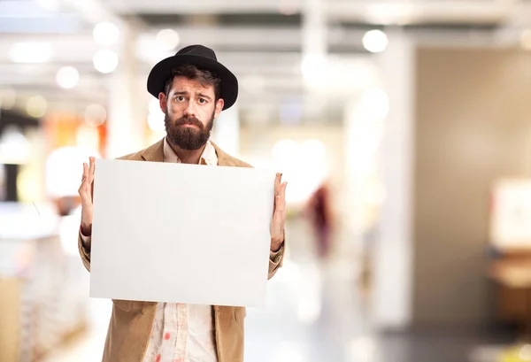 Sad homeless man with placard