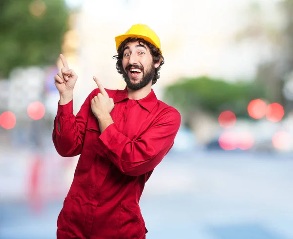 Happy worker man pointing up