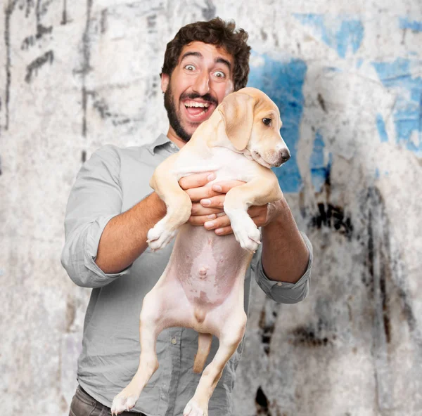 Happy young man with puppy