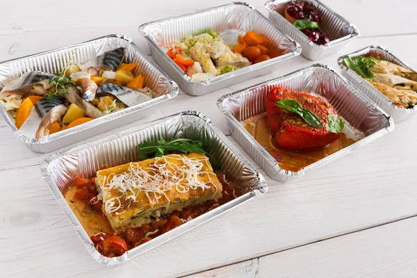 Healthy food take away in boxes on wood