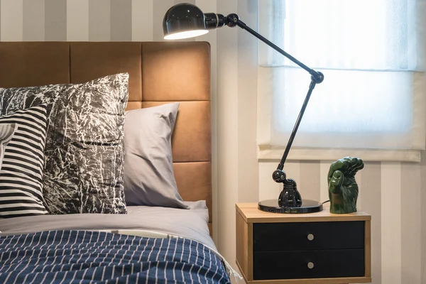 Black modern lamp style on table side in modern bedroom