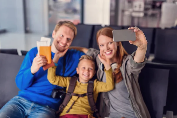 Family waiting for departure at airport