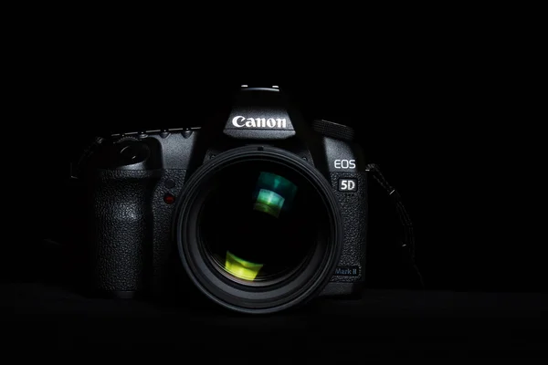 Berlin, Germany  - September 9, 2016: Canon 5D mark 2  interchangeable-lens professional dslr camera on black background,  low key image