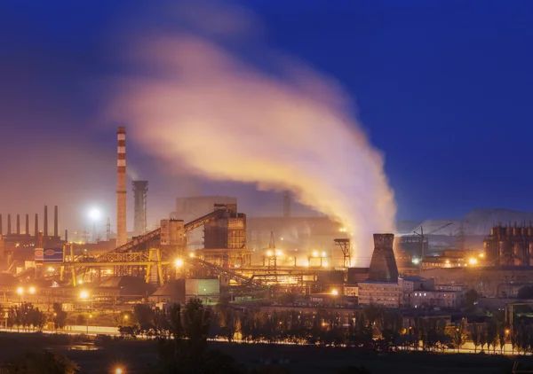 Metallurgical plant at night. Steel factory with smokestacks