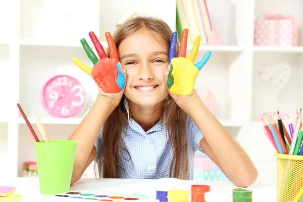 Little girl with painted hands