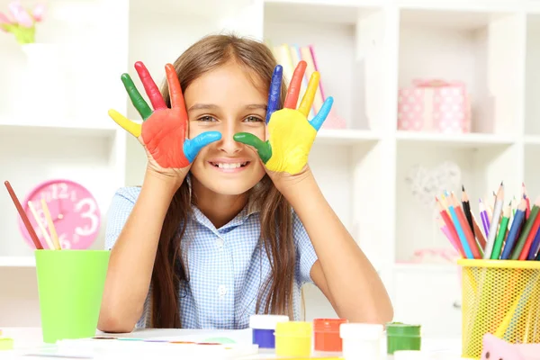 little girl with painted hands