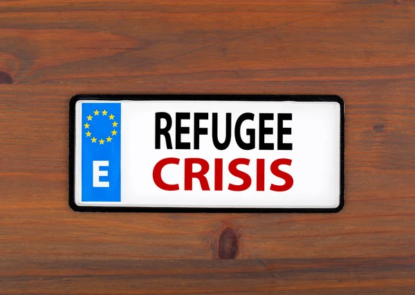 Refugee Crisis. On a wooden board metal plate with european unio