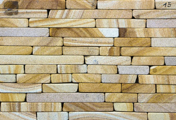 Texture of yellow sandstone bricks close-up,