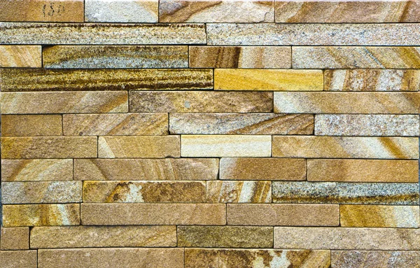 Texture of colored sandstone bricks close-up,