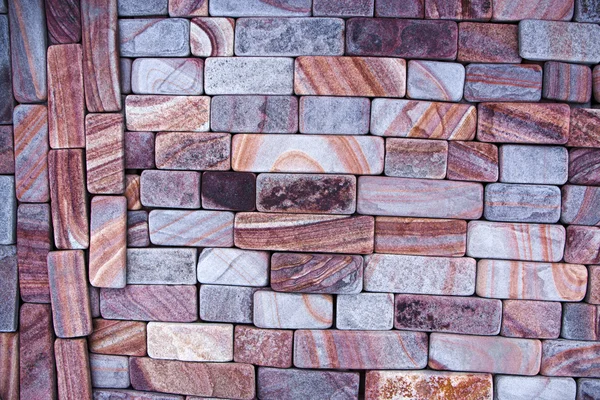 Texture of colored sandstone bricks close-up,