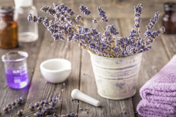 Homemade aromatic lotion with lavender flowers.