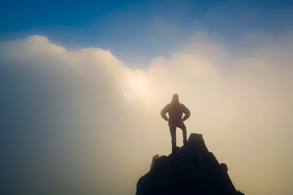 Hiker standing on a cliffs edge