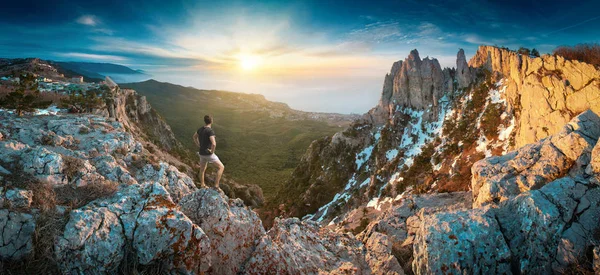 Man standing on a cliffs edge in the Crimea mountains