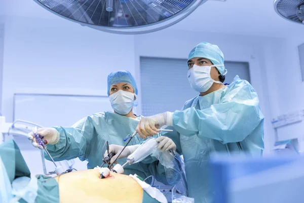 Surgeons performing surgery in operating Theater.
