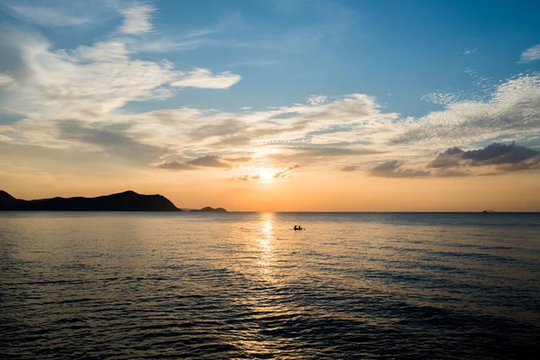 Silhouette sunset evening time in the sea with small boat