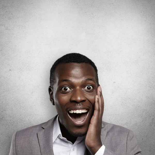 Headshot of attractive African American office worker holding ha