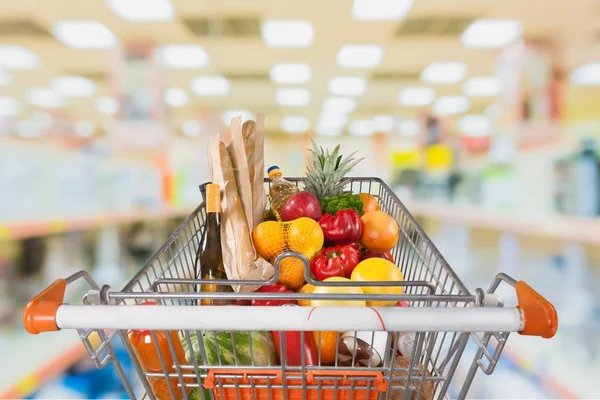 Shopping cart full with various groceries