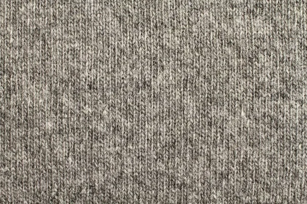 Light gray with black melange knitted wool fabric texture. Macro.