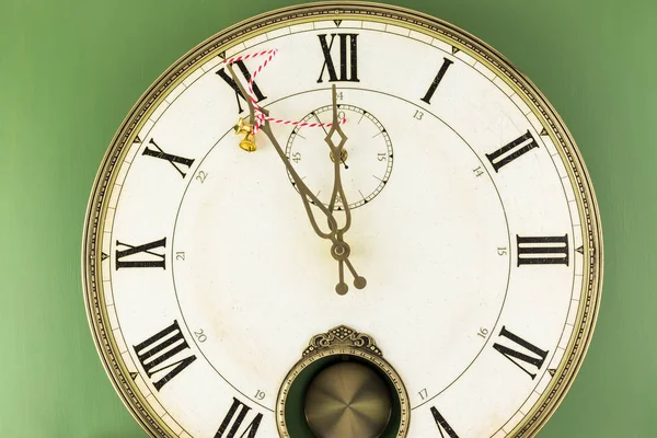 Clock shows five minutes till  New Year.