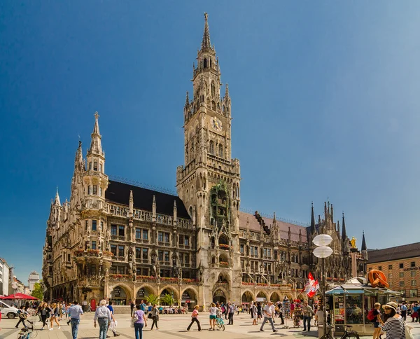 Crowd of tourists are walking near The New Town Hall at the northern part of Marienplatz
