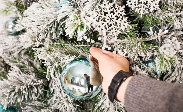 Mans hand with Christmas balls. Winter, party, New Year and Christmas concept