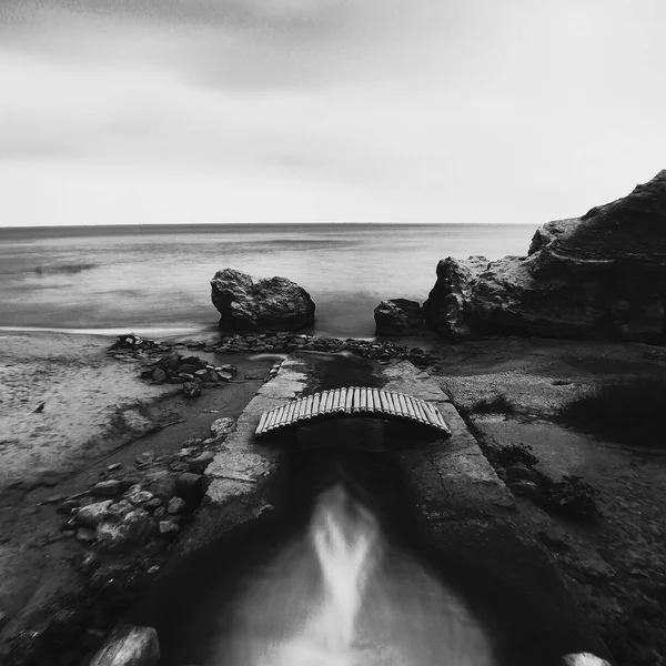 Sea. Black and white. Bridge. Beach