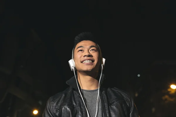 Portrait of a asian young man listening music.