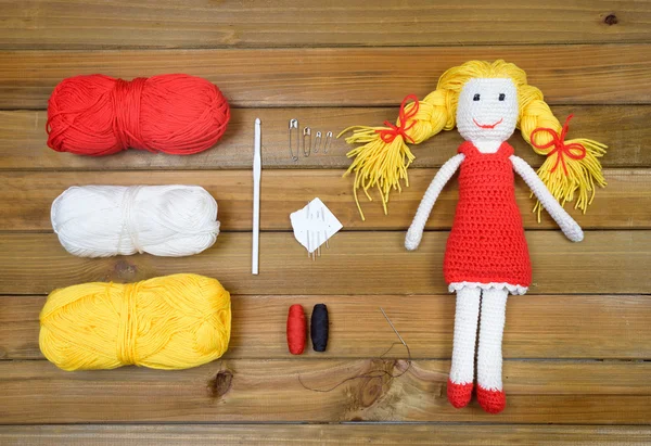 Flat lay of chrochet doll and materials for craft