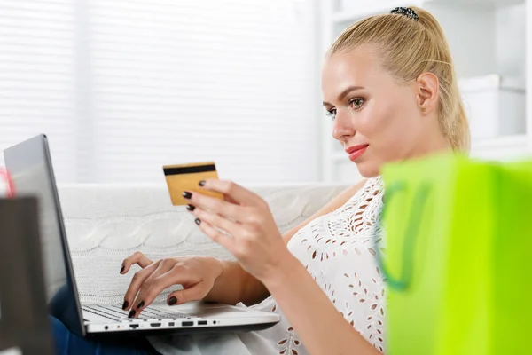 Beautiful blonde woman make shopping via internet