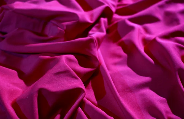 Red wrinkled silk sheets closeup stock image