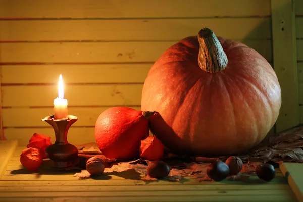 Pumpkin and lamp on wooden table