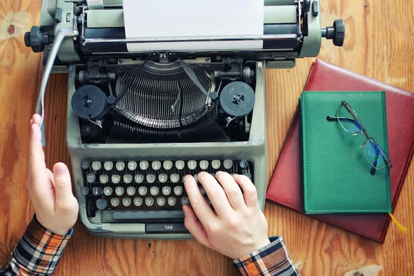 Typewriter retro hand on wooden table