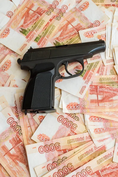 Black gun lies on the Russian big money
