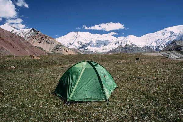 Green tent in the mountains