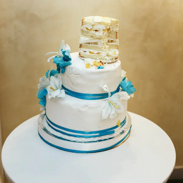 Half-eaten white-blue wedding cake