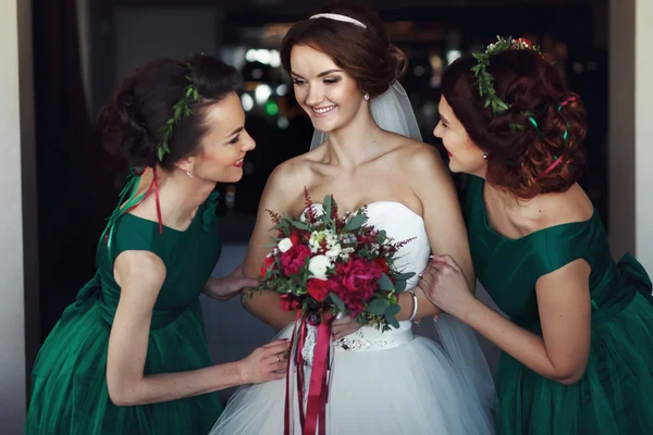 Bridesmaids support a bride before wedding