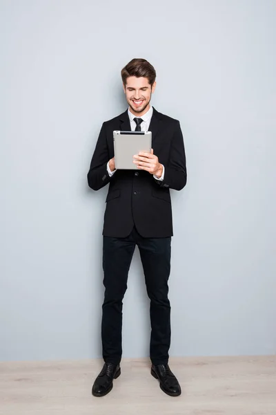 Full portrait of successful businessman using digital tablet