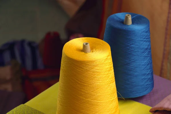 Spools of yellow and blue silk thread for woven in silk in Thail