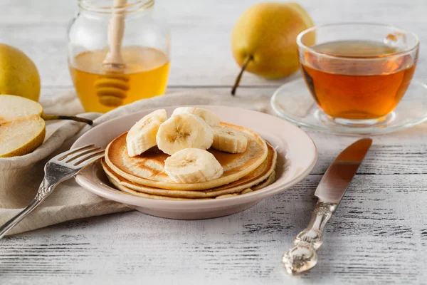 Closeup delicious and healthy breakfast of pancakes with honey,