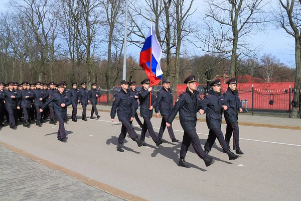 Police officers go a ceremonial step with national flag