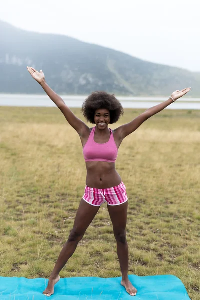 Emale athlete stretching outdoors in mountains