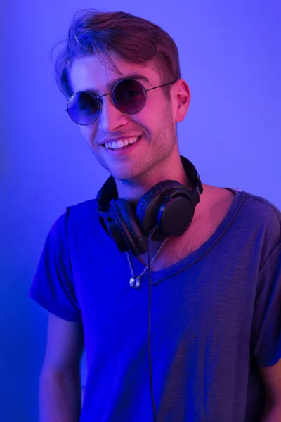 Dj with headphones in nightclub