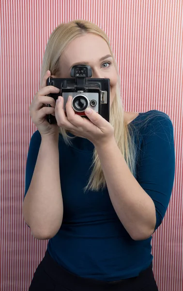 Girl taking photo on retro camera