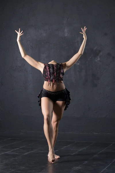 Elegant woman dance in dark studio