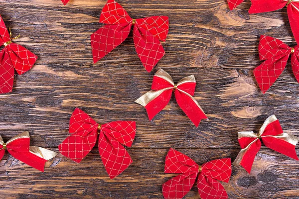 Red bows on a wooden table