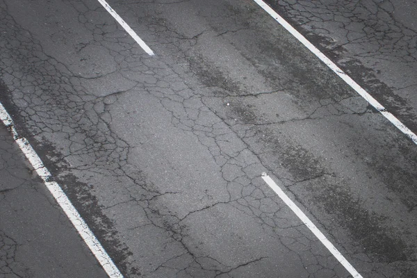 Old road from above -  cracked asphalt street