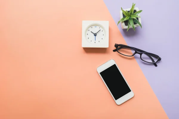 Desk above mobile phone and clock